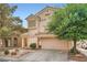 Charming two-story home featuring a well-manicured front yard and an attached two-car garage at 5853 Gentleslope St, Henderson, NV 89011