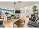 Open-concept living room with hardwood floors, lots of natural light, and modern furnishings at 5853 Gentleslope St, Henderson, NV 89011