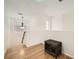 Loft featuring hardwood floors, large windows, modern pendant lights, and a dark wood pet crate at 5853 Gentleslope St, Henderson, NV 89011