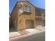Tan two-story home featuring an attached garage, and a small upper balcony at 6158 Calm Breeze Ave # 101, Las Vegas, NV 89108