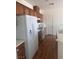 Kitchen features wood-style flooring, white appliances and bright white countertops at 6158 Calm Breeze Ave # 101, Las Vegas, NV 89108