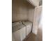 This laundry room features a white washing machine and dryer with shelving above at 6158 Calm Breeze Ave # 101, Las Vegas, NV 89108