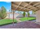 Backyard with lush greenery, decorative brickwork, and a covered patio, ideal for outdoor relaxation and entertaining at 6408 Shawnee Pl, Las Vegas, NV 89107