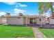Well-maintained backyard features lush grass, a covered patio, and a charming stone pathway leading through the yard at 6408 Shawnee Pl, Las Vegas, NV 89107