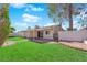Lush backyard offering a blend of green lawn, brick patio, and a covered area, perfect for outdoor enjoyment at 6408 Shawnee Pl, Las Vegas, NV 89107