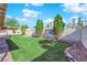 Lush backyard with a well-maintained lawn, trimmed hedges, and a decorative brick border defining the garden beds at 6408 Shawnee Pl, Las Vegas, NV 89107