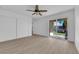Bedroom with sliding glass doors to the outside and hardwood floors, with a ceiling fan at 6408 Shawnee Pl, Las Vegas, NV 89107
