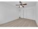 Bedroom featuring a ceiling fan, closet with white doors, light walls, and light wood floors at 6408 Shawnee Pl, Las Vegas, NV 89107