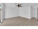 Bedroom with hardwood floors, white walls, a ceiling fan, and sliding glass door at 6408 Shawnee Pl, Las Vegas, NV 89107