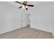 Bedroom featuring a ceiling fan, light walls, and light wood floors at 6408 Shawnee Pl, Las Vegas, NV 89107