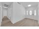 Clean entryway with hardwood floors, white walls, and a decorative white door at 6408 Shawnee Pl, Las Vegas, NV 89107