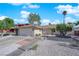 Well-maintained single-story home with a two-car garage, desert landscaping, and a brick-paved walkway at 6408 Shawnee Pl, Las Vegas, NV 89107