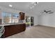Contemporary kitchen with stainless steel appliances, dark wood cabinets, and sliding glass doors to backyard at 6408 Shawnee Pl, Las Vegas, NV 89107