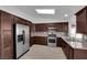 Modern kitchen with stainless steel appliances, granite countertops, dark wood cabinetry, and a skylight at 6408 Shawnee Pl, Las Vegas, NV 89107