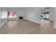 Spacious living room featuring a white brick fireplace, hardwood floors, and sliding glass door at 6408 Shawnee Pl, Las Vegas, NV 89107