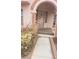 Well-lit home entrance with stone archway and walkway at 6561 Avon Ct, Las Vegas, NV 89108