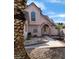 Charming two-story home with a unique archway entrance and a well-maintained front yard landscape at 6561 Avon Ct, Las Vegas, NV 89108
