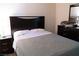 Comfortable bedroom features a stylish dark wood bedroom set, providing ample storage and sleep space at 6631 Frosted Harvest Ave, Las Vegas, NV 89108
