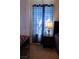 Bedroom features a black nightstand with a charming lamp beside a stylish window with curtains at 6631 Frosted Harvest Ave, Las Vegas, NV 89108