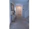 Entryway boasts neutral carpet, white walls, and a console table, leading to the front door and stairs at 6631 Frosted Harvest Ave, Las Vegas, NV 89108