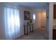 Inviting entryway with carpet flooring, adorned with a decorative table and floral artwork at 6631 Frosted Harvest Ave, Las Vegas, NV 89108