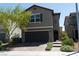 Charming two-story home features a front yard with desert landscaping and an attached two-car garage at 6631 Frosted Harvest Ave, Las Vegas, NV 89108