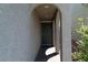Arched alcove entry featuring a dark front door, with a textured stucco exterior wall at 6631 Frosted Harvest Ave, Las Vegas, NV 89108
