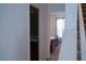 Hallway view showcasing the staircase, a full bathroom and a bedroom with natural light at 6631 Frosted Harvest Ave, Las Vegas, NV 89108