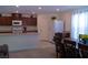 Bright kitchen and dining area with granite countertops, stainless appliances, adjacent dining table, and lots of natural light at 6631 Frosted Harvest Ave, Las Vegas, NV 89108