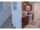 Inviting kitchen with stairs, featuring granite countertops, stainless steel appliances, and ample cabinet space at 6631 Frosted Harvest Ave, Las Vegas, NV 89108