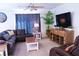 Cozy living room with a plush sectional sofa, ceiling fan, television, and decorative accents at 6631 Frosted Harvest Ave, Las Vegas, NV 89108