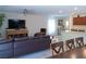 Open-concept living room featuring a large sectional couch and seamless flow to the kitchen at 6631 Frosted Harvest Ave, Las Vegas, NV 89108