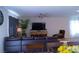Spacious living room with a comfortable sectional couch and modern ceiling fan at 6631 Frosted Harvest Ave, Las Vegas, NV 89108