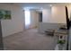 Open living room featuring neutral paint, plush carpet, and large windows at 6631 Frosted Harvest Ave, Las Vegas, NV 89108