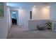 Open living room featuring neutral paint, plush carpet, and access to other rooms at 6631 Frosted Harvest Ave, Las Vegas, NV 89108