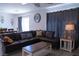 Comfortable living room with plush sectional sofa, stylish decor, and ample natural light at 6631 Frosted Harvest Ave, Las Vegas, NV 89108