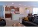 Open-concept living room flows into a kitchen with stainless appliances and granite countertops at 6631 Frosted Harvest Ave, Las Vegas, NV 89108