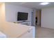 Upstairs hallway with a console table and television at 6631 Frosted Harvest Ave, Las Vegas, NV 89108