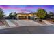 Well maintained house with a three-car garage and gated driveway on a paved street at 6907 Kelp Ledge Ct, Las Vegas, NV 89131