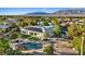 Expansive backyard featuring a pool, desert landscaping, and solar panels with mountain views at 6907 Kelp Ledge Ct, Las Vegas, NV 89131