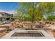 Inviting community area with picnic tables, benches, and a fire pit, perfect for outdoor gatherings and relaxation at 694 Last Dance Pl, Henderson, NV 89011