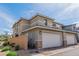 Attractive townhome with a neutral exterior paint job and two-car garage at 694 Last Dance Pl, Henderson, NV 89011