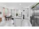 Bright open floor plan kitchen and dining with island, tile floor and stainless refrigerator at 694 Last Dance Pl, Henderson, NV 89011