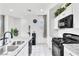 Bright kitchen features granite countertops, stainless appliances and white cabinets at 694 Last Dance Pl, Henderson, NV 89011