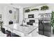 Modern kitchen with granite countertops, a stainless steel fridge, and white cabinetry at 694 Last Dance Pl, Henderson, NV 89011