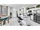 Bright open floor plan kitchen and dining with island, tile floor and stainless refrigerator at 694 Last Dance Pl, Henderson, NV 89011