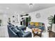 Open-concept living room is furnished with comfortable seating and neutral décor; great for entertaining at 694 Last Dance Pl, Henderson, NV 89011