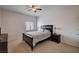Bedroom with carpet, ceiling fan, wooden bed frame, side tables, and neutral walls at 7701 W Robindale Rd # 206, Las Vegas, NV 89113