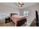 Bedroom with carpet, ceiling fan, wooden bed frame, side tables, and neutral walls at 7701 W Robindale Rd # 206, Las Vegas, NV 89113