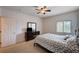 Bedroom with carpet, ceiling fan, wooden bed frame, side tables, and neutral walls at 7701 W Robindale Rd # 206, Las Vegas, NV 89113